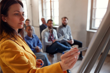 Business woman leading meeting in conference room.