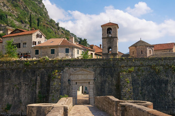 Montenegro . Old Town of Kotor, UNESCO-World Heritage Site. View of northern walls of ancient fortress, River Gate and church of St. Mary