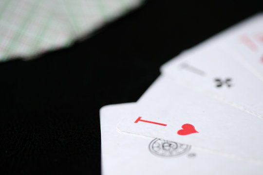 Playing cards on a dark background close up