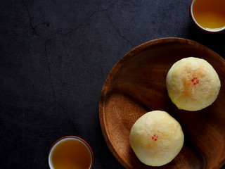 Mid-autumn festival is a traditional festival of East Asian culture and folk. Top view of mung bean pastry and Oolong tea on wooden background. With copy space.  Flat lay.  Taiwan food.