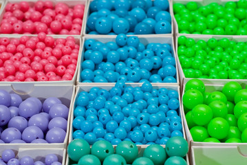 close up multi colored beads heap in box