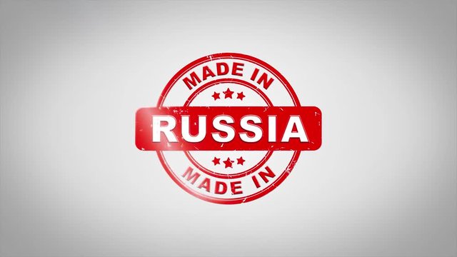 Made In RUSSIA Signed Stamping Text Wooden Stamp Animation. Red Ink on Clean White Paper Surface Background with Green matte Background Included.