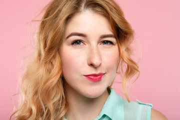 Naklejka premium emotion face. suspicious thoughtful dubious skeptic distrustful woman. young beautiful girl portrait on pink background.