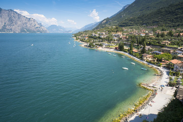 Fototapeta na wymiar Panoramic view of Lake Garda and the village of Malcesine, Italy. Lake Garda and its surroundings are a holiday area appreciated by many European tourists.