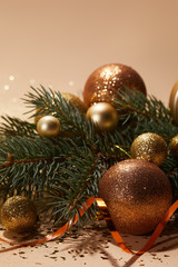 glittering christmas balls on pine branch on tabletop