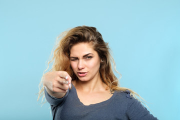 confident beautiful seductive woman pointing a finger gun at you. femme fatale aiming for your...