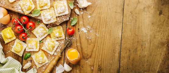 Cooking italian ravioli on wooden table