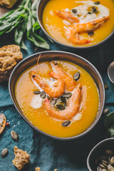 Autumn pumpkin creamy soup in bowls