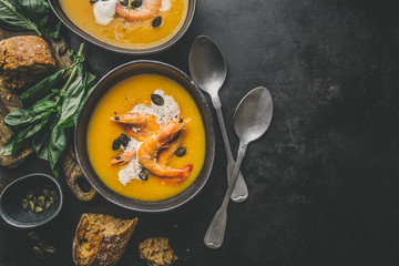 Autumn pumpkin creamy soup in bowls