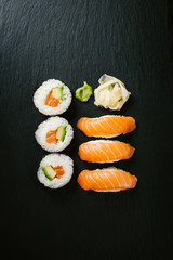Sushi served on plate on dark table