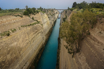 Fototapeta premium Corinth, Greece: A ship travels through the narrow passage of the Corinth Canal.