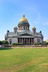 Saint Isaac's Cathedral in St. Petersburg, Russia. Church Facade Building Architecture View with Empty Green Grass Park Glade. Saint Isaac Cathedral City Attraction on Sunny Summer Day Background