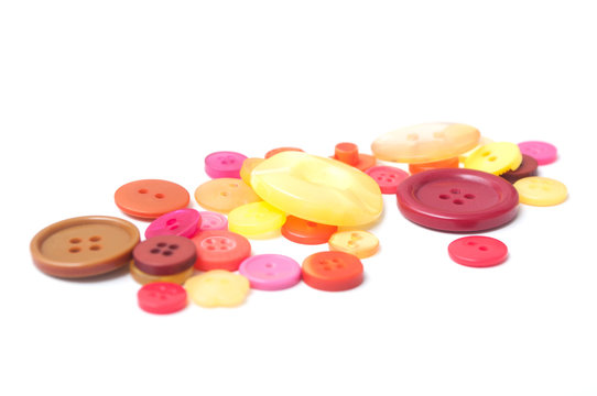 closeup of red and orange buttons on white background