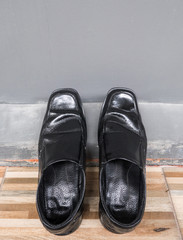 Old black leather shoes.