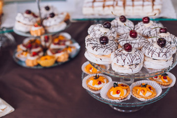 Delicious wedding reception candy bar dessert table. A lot of alcohol and glasses. Coktails and sweets. Wedding party table.