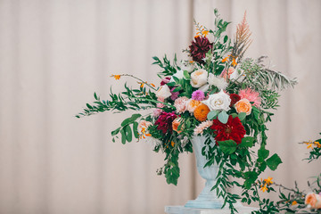 Table set for wedding or another catered event dinner. Catering in restaurant for wedding party. Served tables with pink and red flowers. 
