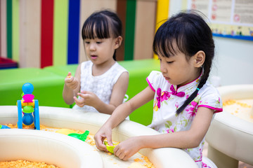Asian Chinese Little Sisters Playing Kinetic Sand