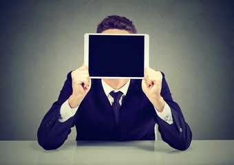 Businessman with tablet instead of face