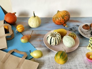 Autumn composition of pumpkins of different varieties, cupcakes, pears, cookie shapes, preparation...
