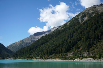 High situated reservoir in Austria with mountains in the background
