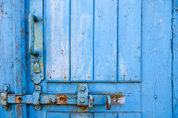 door lock for key closing, keyhole, hasp bolt. Collection of old vintage retro locks on the textured colored door. Close-up