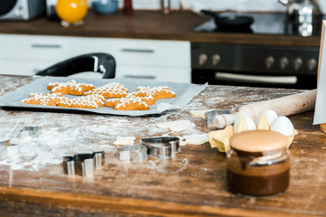 close-up view of chocolate spread and delicious ginger cookies on baking tray