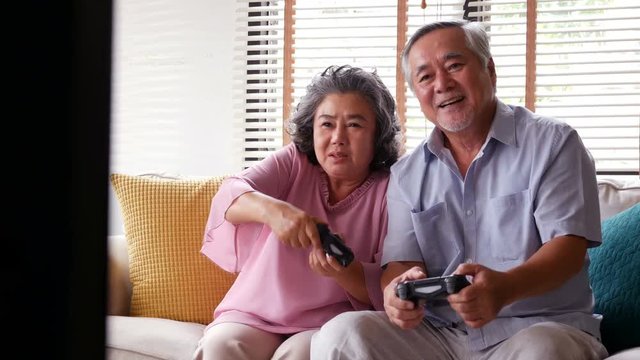 Senior man and woman playing game together at home with happy emotion. People with happy, lifestyle, entertainment concept. 4k resolution.
