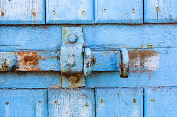 door lock for key closing, keyhole, hasp bolt. Collection of old vintage retro locks on the textured colored door. Close-up