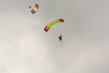 The parachutist flies. The paratrooper is in the air. Parachute flight.