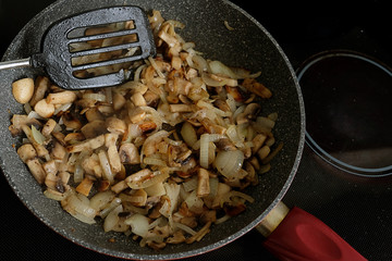 fried mushrooms with onions in a frying pan