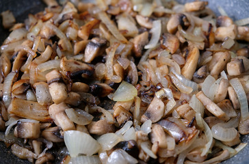 fried mushrooms with onions in a frying pan
