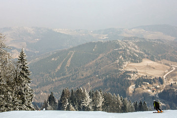 The skier is rolling down from the top of the snow-capped hill on the alpine skiing. Alps, ski...