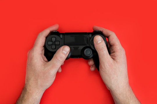Man playing video game holding gaming controller in hands