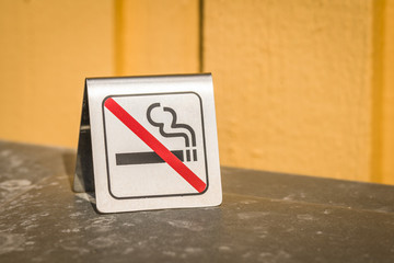 No smoking metal sign on a table
