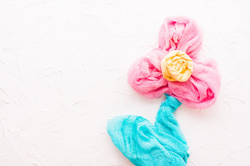Handmade concept of fabric on a concrete background. Bright flower on a white background.  Copy space