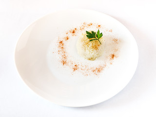 Rise served on a white plate garnish with paprika and parsley leaf. White background, space for text