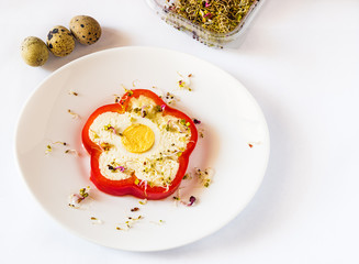 Slice of pepper stuffed with sheep cheese and eggs on white plate and white background. 