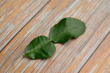 Green bergamot leaf on the wood background