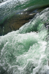 Rough stormy water in the river as a backdrop Wave or rapid current vertical background