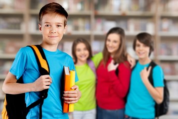 School boy with books and backpack