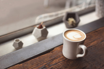 Cup of coffee near the window