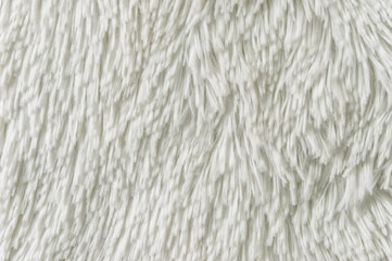 Fluffy plaid of polyester with a long heap gray. Comfortable home textiles. Background, texture
