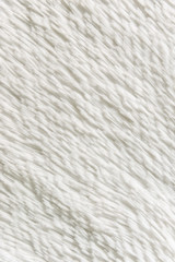 Fluffy plaid of polyester with a long heap gray. Comfortable home textiles. Background, texture