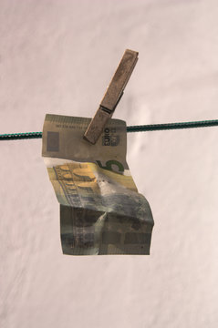 Close-up of a five euro bill hanging a thread hanging clothes