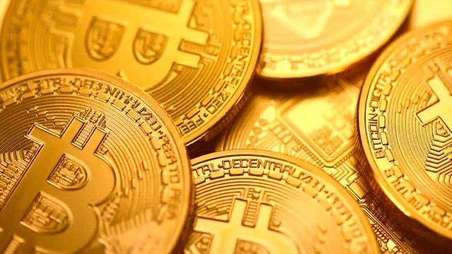Bitcoin crypto currency. BTC coins closeup. Blockchain technology, Bitcoin mining concept. Rotation 360 degrees. 4K UHD video 3840x2160