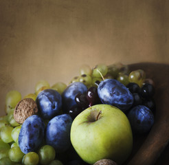 Naklejka na ściany i meble Seasonal thanksgiving fruit in wooden bowl.