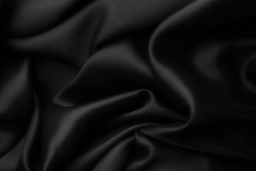Elegant black satin silk with waves, abstract background.