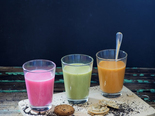 Thai tea and green tea and  pink milk isolated on dark background.