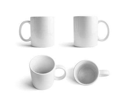 White ceramic mugs. Cups for coffee or tea isolated on white background. Responsive design mockup.