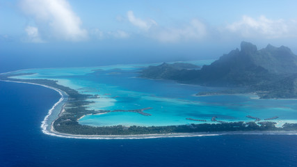 Flying Over Bora Bora's Blue Lagoon In French Polynesia - obrazy, fototapety, plakaty